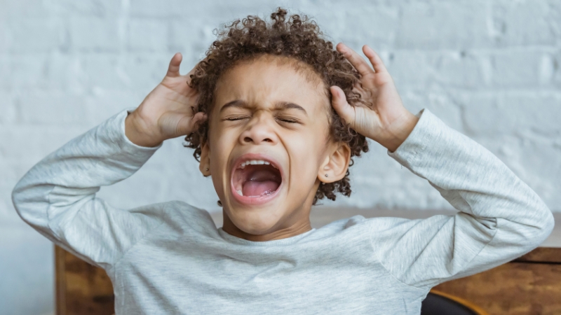 Decorative image of a child screaming in exasperation with his hands on his head
