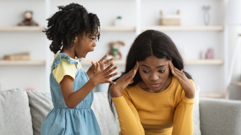 Decorative image of a mother holding her head in her hands while her daughter screams